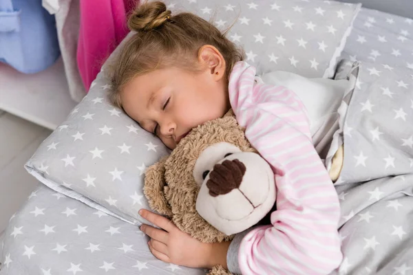 Adorable little kid sleeping with teddy bear — Stock Photo