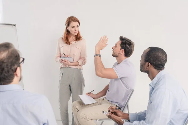 Cropped shot of middle aged multiethnic people talking together during anonymous group therapy — Stock Photo
