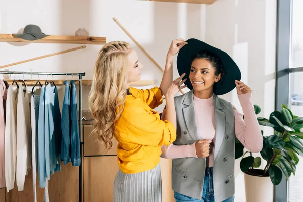 Young stylish shopping buddies spending time in clothing store — Stock Photo