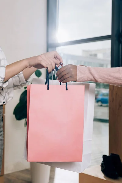 Store manager giving packages to customer — Stock Photo