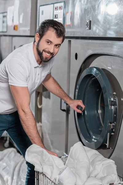 Dry cleaning worker opening industrial washing machine — Stock Photo