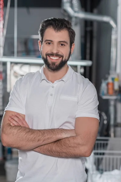 Dry cleaning worker with crossed arms — Stock Photo