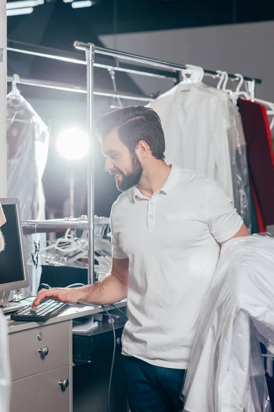 Reinigungskraft benutzt Computer im Lager — Stockfoto