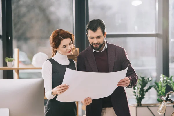 Two architects working with blueprint in office — Stock Photo