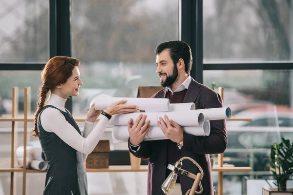 Two happy architects working with blueprints in modern office — Stock Photo