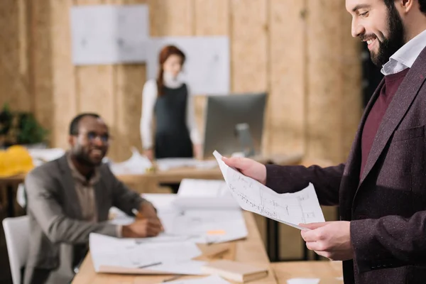 Équipe d'architectes travaillant ensemble dans un bureau élégant — Photo de stock