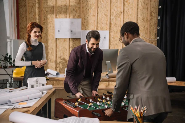 Architects playing table football at modern office — Stock Photo