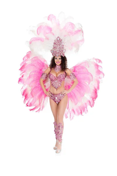 Smiling girl posing in carnival costume with pink feathers, isolated on white — Stock Photo