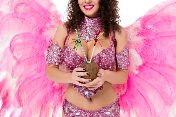 Cropped image of woman in carnival costume holding coconut with straws and smiling, isolated on white — Stock Photo