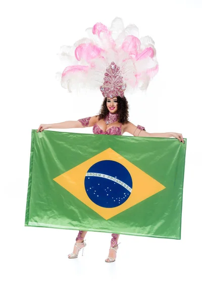 Bright woman in carnival costume with pink feathers holds flag of Brasil isolated on white — Stock Photo