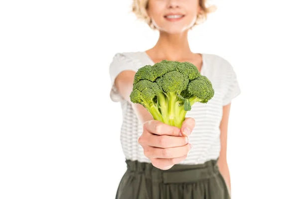 Close-up view of young woman holding fresh raw broccoli isolated on white — Stock Photo