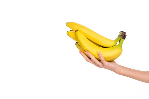 Primer plano vista parcial de la mujer sosteniendo plátanos maduros frescos aislados en blanco — Stock Photo