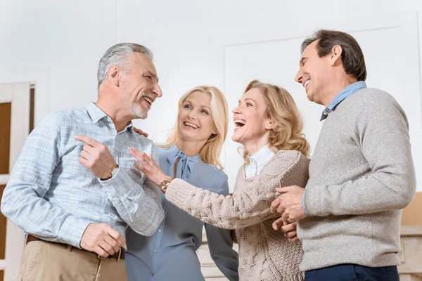 Happy friends spending time with each other at room interior — Stock Photo