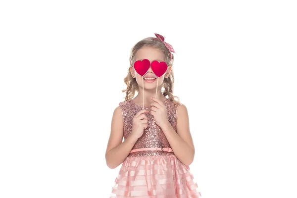Beautiful smiling little child in pink dress holding red hearts on sticks isolated on white — Stock Photo