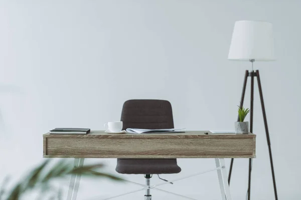 Silla y mesa de madera en la oficina aislado en gris - foto de stock