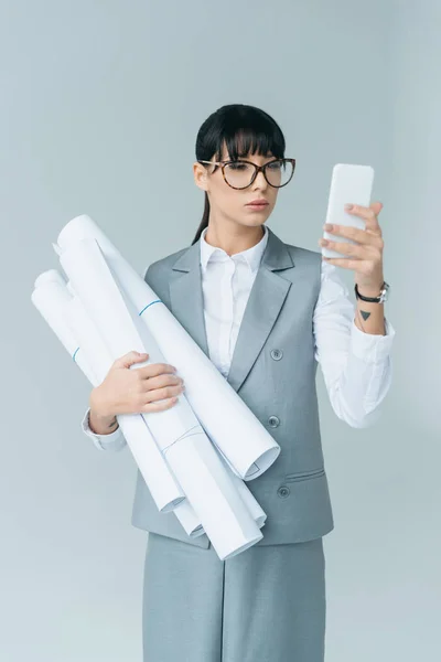 Geschäftsfrau hält Baupläne in der Hand und macht Selfie mit Smartphone — Stockfoto