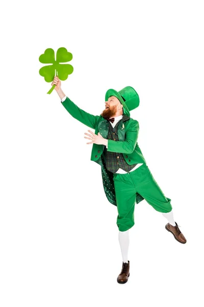 Leprechaun in green suit holding clover, isolated on white — Stock Photo