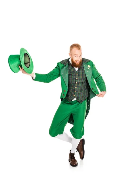 Handsome leprechaun in green costume holding hat, isolated on white — Stock Photo