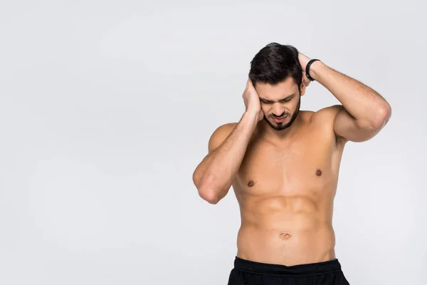 Shirtless young athletic man with headache isolated on white — Stock Photo