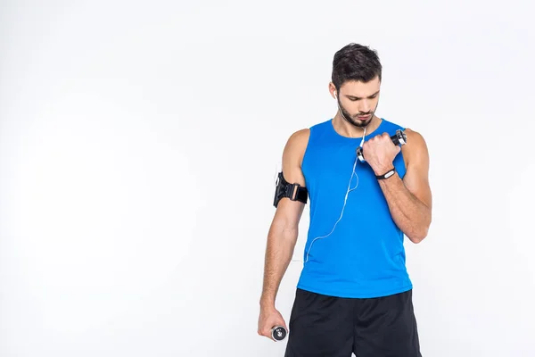 Handsome young man working out with dumbbells isolated on white — Stock Photo