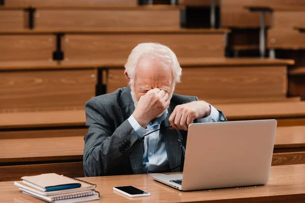 Tired grey hair professor touching nose bridge — Stock Photo