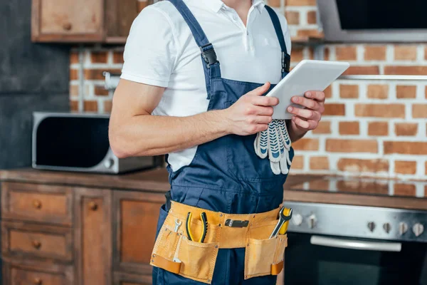 Cropped shot of professional home master using digital tablet — Stock Photo