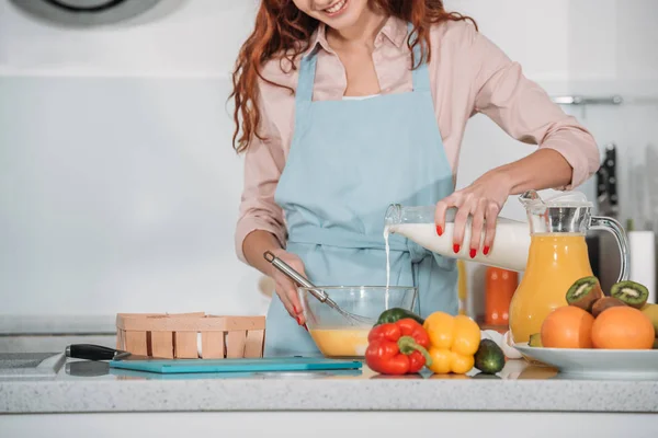 Imagem cortada de mulher derramando leite na tigela para preparar a massa — Fotografia de Stock