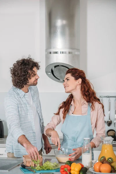 Copine préparant la pâte et regardant petit ami — Photo de stock