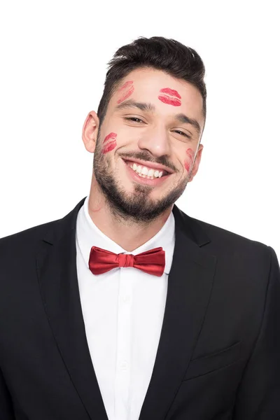 Laughing handsome man with lips traces on face isolated on white — Stock Photo