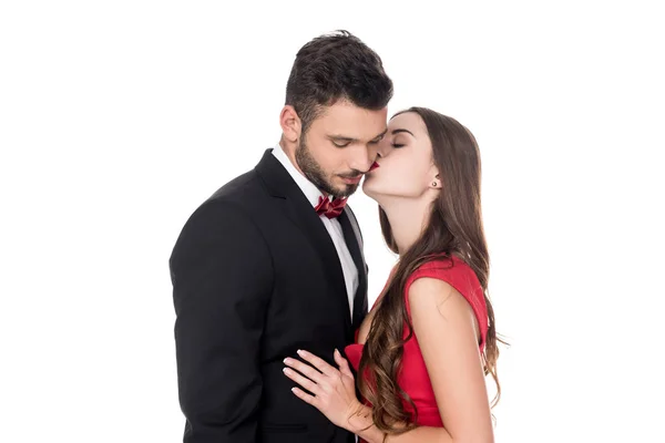 Side view of girlfriend kissing boyfriends cheek isolated on white — Stock Photo