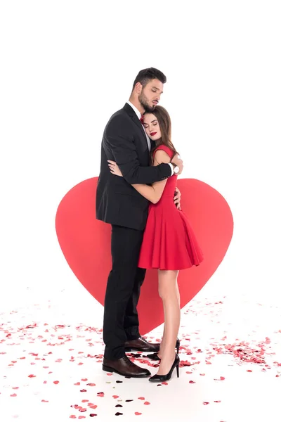 Couple hugging near big heart on white, valentines day concept — Stock Photo