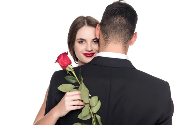 Girlfriend hugging boyfriend and holding rose isolated on white, valentines day concept — Stock Photo