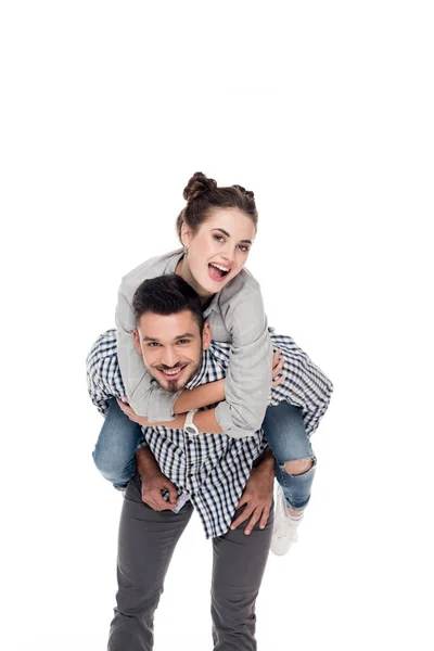 Happy boyfriend giving piggyback to girlfriend isolated on white — Stock Photo