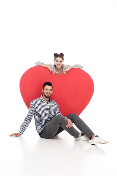 Happy couple near big heart on white, valentines day concept — Stock Photo