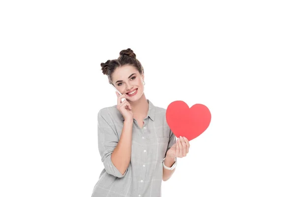 Girl holding paper heart and talking by smartphone isolated on white, valentines day — Stock Photo