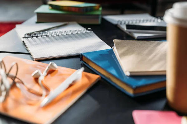 Notebooks and books for studying on black table — Stock Photo