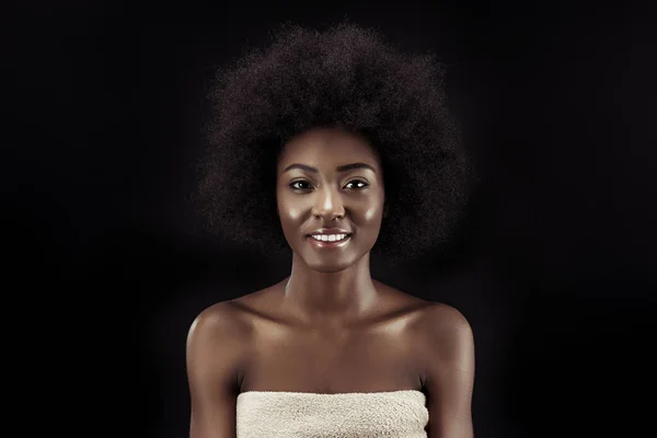 Attractive african american woman looking at camera isolated on black — Stock Photo