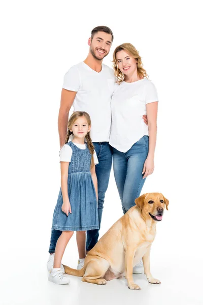 Smiling parents and daughter with golden retriever dog, isolated on white — Stock Photo