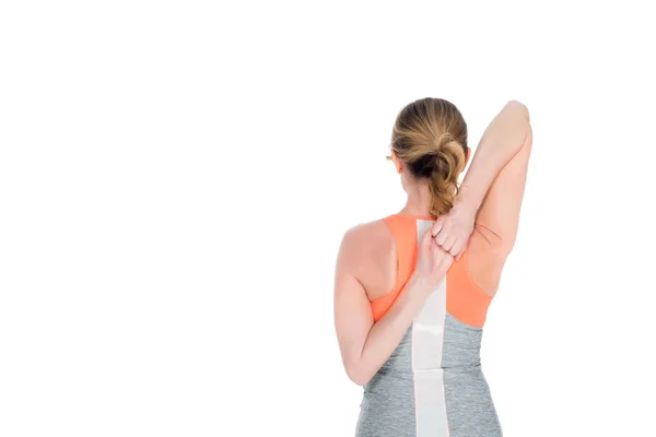 Back view of sportswoman stretching before training isolated on white — Stock Photo