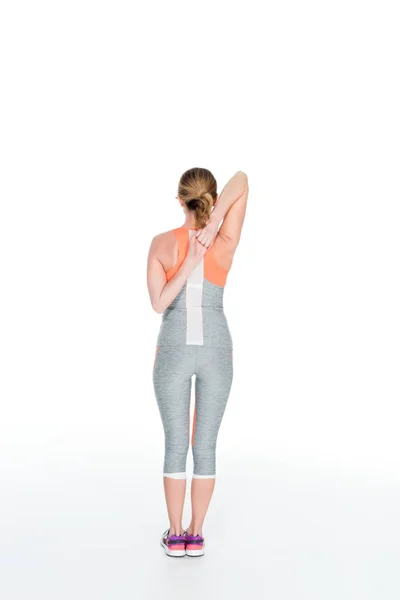 Vista posteriore dello sport stretching prima dell'allenamento isolato su bianco — Foto stock