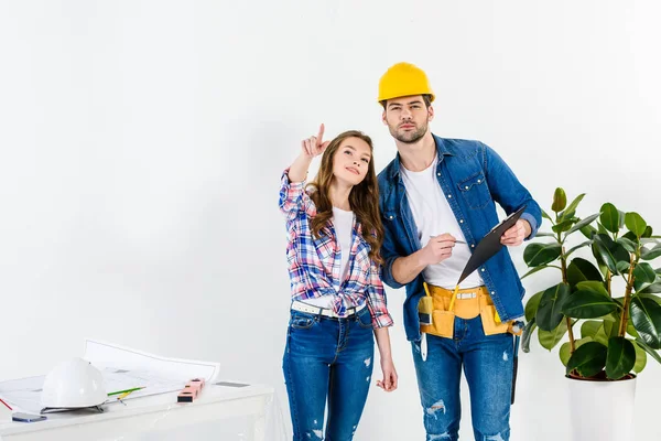 Proprietário do apartamento apontando sobre algo para trabalhador — Fotografia de Stock