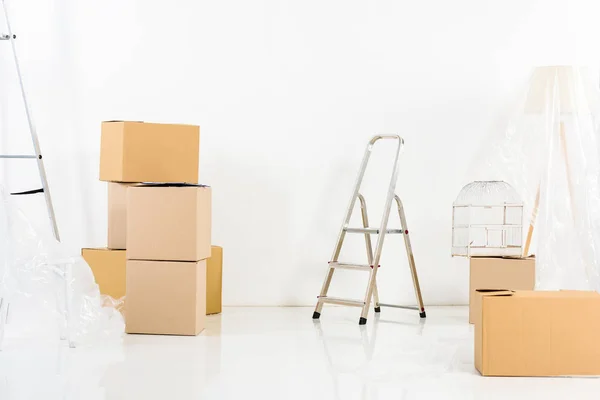 Ladders and boxes in new empty apartment — Stock Photo