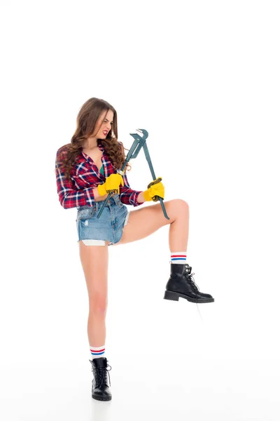 Beautiful sexy girl posing with adjustable wrench, isolated on white — Stock Photo
