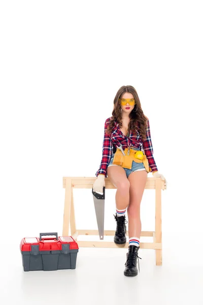 Beautiful sexy girl posing with saw and toolbox, isolated on white — Stock Photo