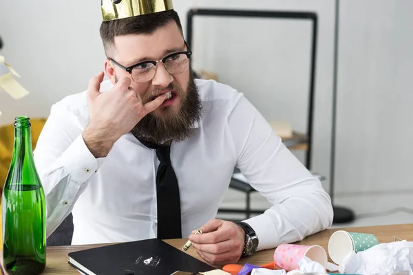 Businessman taking drugs at workplace in office — Stock Photo