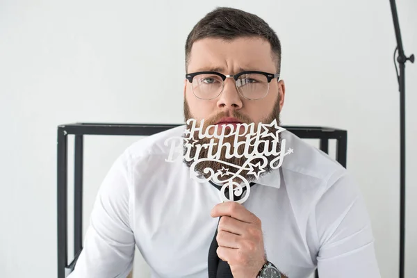 Portrait of businessman in formal wear with happy birthday sign — Stock Photo