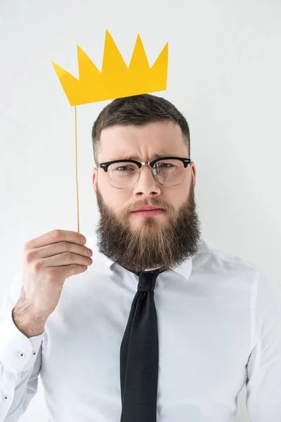 Portrait of bearded businessman in formal wear with paper crown isolated on grey — Stock Photo