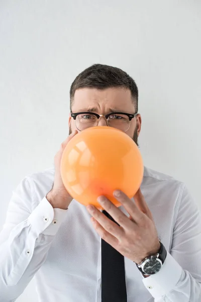 Portrait of businessman in formal wear with balloon isolated on grey — Stock Photo