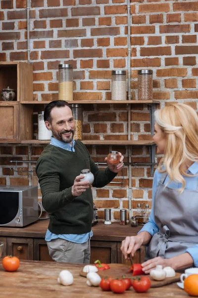 Husband proposing wife spices in kitchen — Stock Photo