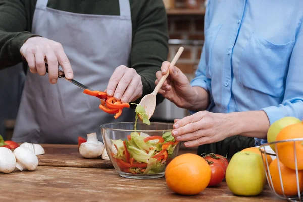 Abgeschnittenes Bild eines Paares, das Salat zubereitet — Stockfoto